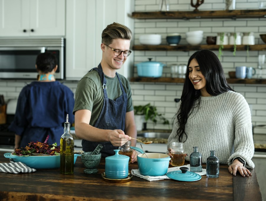 A family cooking together in a bright, well-stocked kitchen