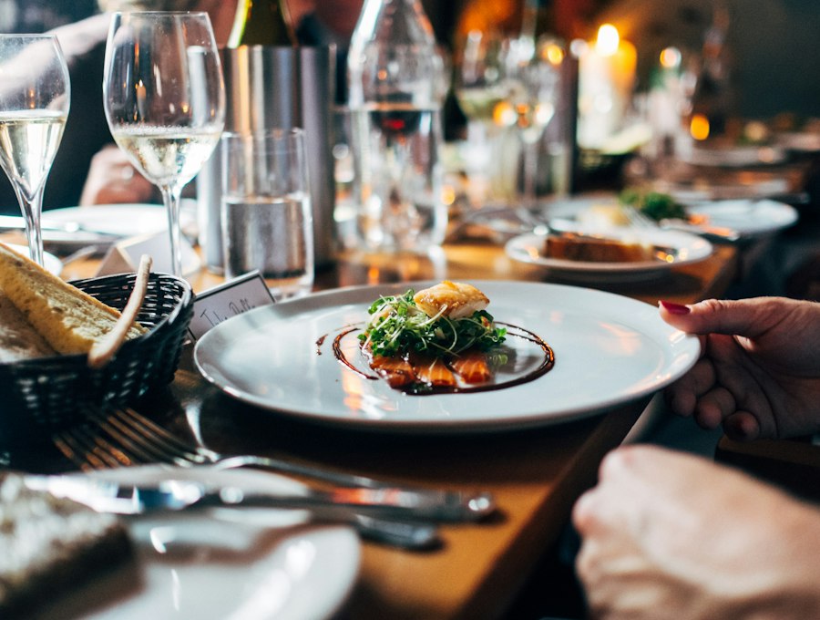 A beautifully plated dish being served at a dinner event