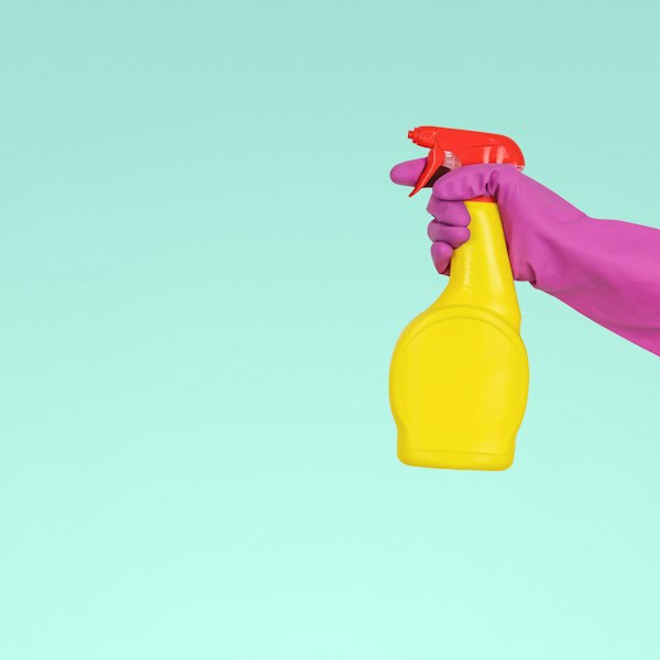 A spray bottle and cleaning gloves — the supplies carried by every ValueMaids cleaner